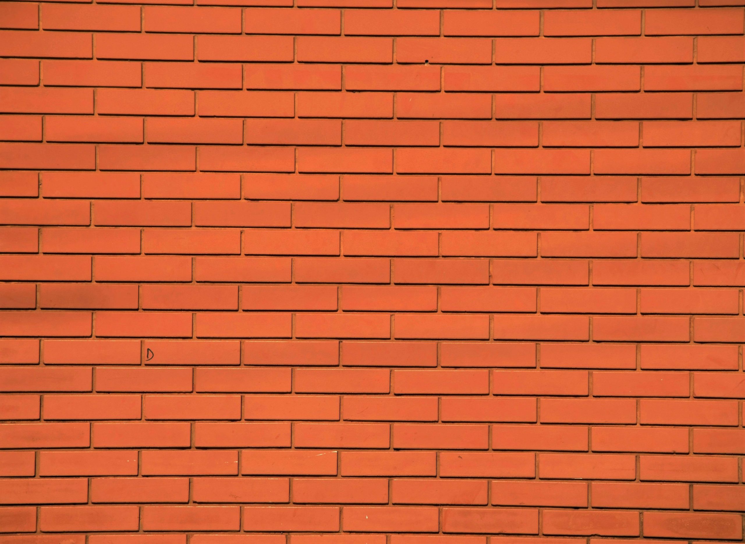 Orange brick wall with consistent pattern, perfect for background or texture use.