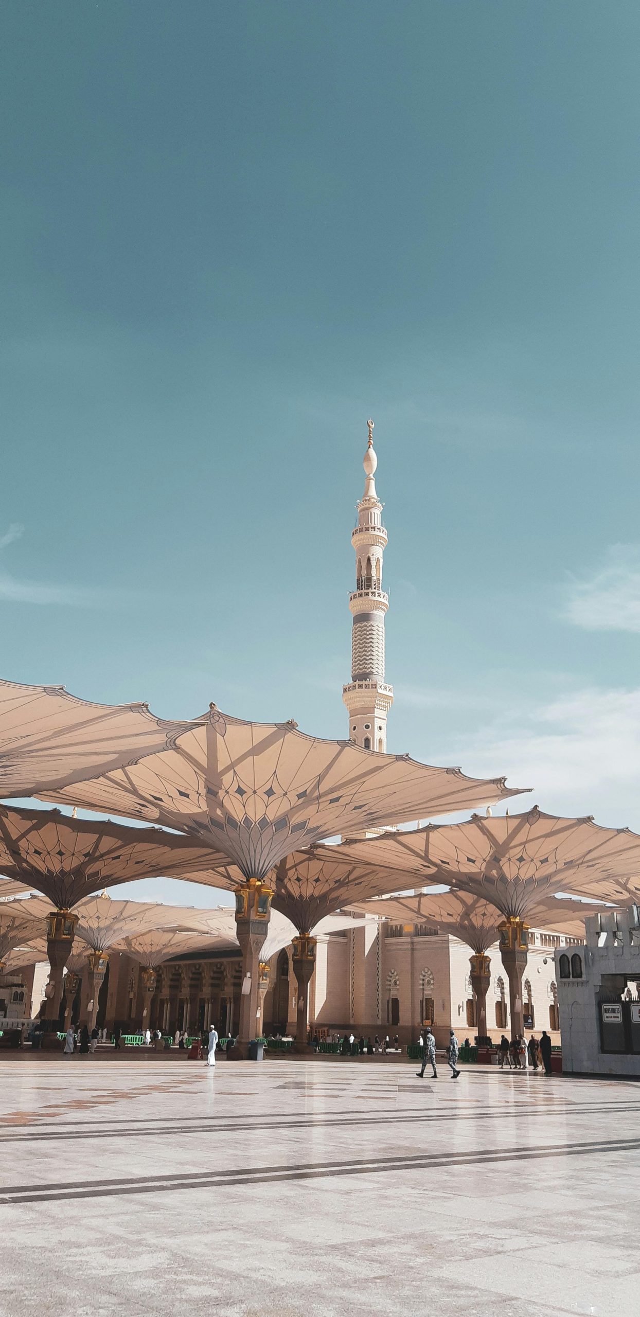 View of the Prophet's Mosque courtyard in Medina, capturing the architectural beauty under a clear sky.